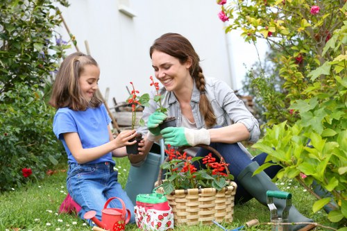 Gardener at work in a Raynes Park garden near terraced houses