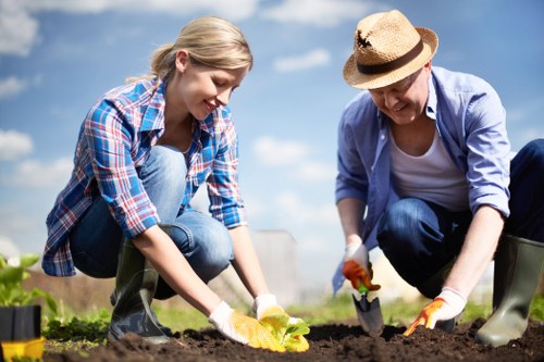 Gardener inspecting a garden with tools nearby
