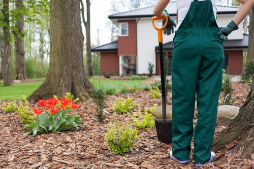Worker checking PPE checklist before starting gardening tasks