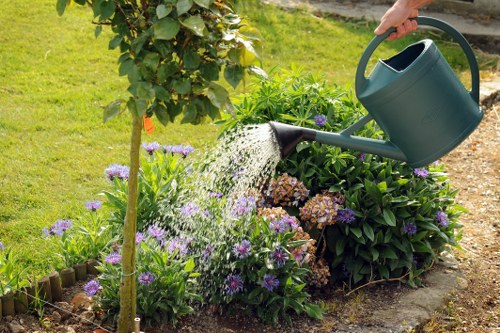 Satisfied customer with their garden maintained by Gardeners Raynes Park
